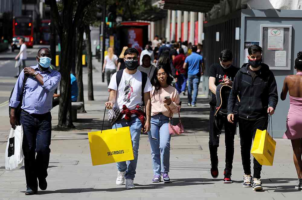 Pedestrians carry shopping bags, amid the Covid-19 outbreak, in London, Britain July 18, 2020. u00e2u20acu201d Reuters pic